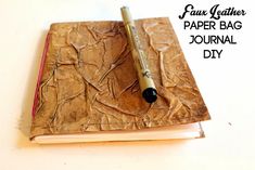 a book with a pen on top of it and the title fau leather paper bag journal diy