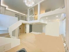 an empty room with white walls and wood flooring in the foreground is being remodeled