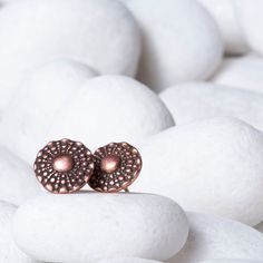 Designed with a contemporary sophistication, these gorgeous Vintage Button Sun Beam Copper Stud Earrings by Jester Swink are both trendy and vintage. Handcrafted with finesse, the pair of earrings come in copper now and eventually sterling silver. Lightweight and fashionable, you can pair them up with a heavy necklace to complete the look or simply go solo at home or work. These round studs are appx 13mm in diameter and promise the finest quality, supreme comfort, and a stylish look. So what are Heavy Necklace, Vintage Button, Copper Jewelry, Beams, Jewelry Box, Pearl Earrings, Jewelry Design, Copper, Stud Earrings