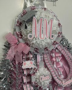 a pink and silver christmas tree with the word moo on it