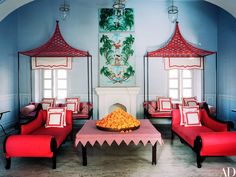 an image of a living room with red furniture