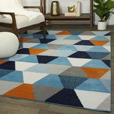 a living room with a chair and rug on the floor