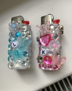 two lighters with different designs on them sitting next to each other