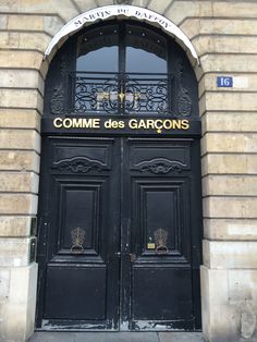 two black doors are open in front of a building