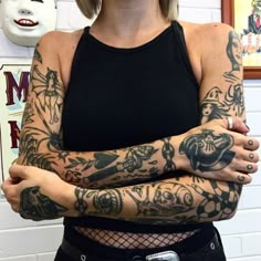 a woman with tattoos on her arm and arms