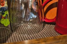 several different colored vases sitting on top of a table