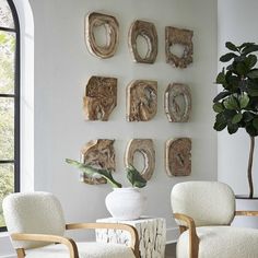 a living room filled with furniture next to a wall covered in pictures and art pieces