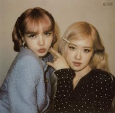 two young women are posing for the camera with their hair pulled back and bangs down