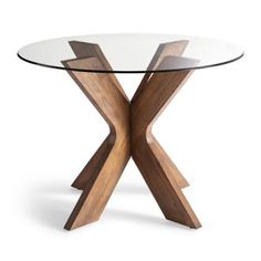 a glass table with wooden legs and an x design on the top that is made out of wood