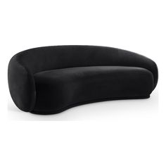 a black curved couch sitting on top of a white floor next to a wall mounted clock