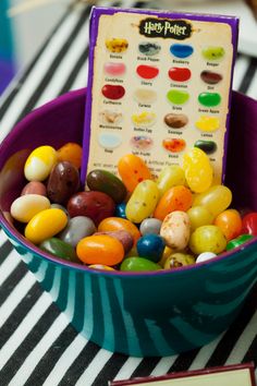 a bowl filled with jelly beans sitting on top of a table