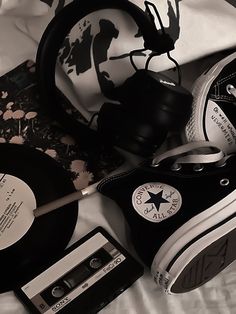 black and white photograph of various items on top of a bed, including an old record player