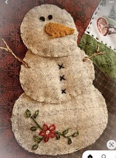 a close up of a snowman made out of fabric