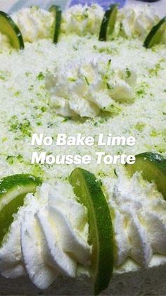 a cake with limes and whipped cream on top