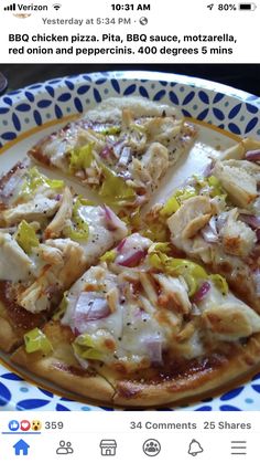 a pizza with chicken and peppers on it sitting on a blue and white platter