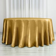 a gold table cloth on top of a round table