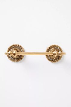 a pair of gold colored metal handles on a white background