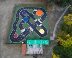 an overhead view of a play area with cars and roads