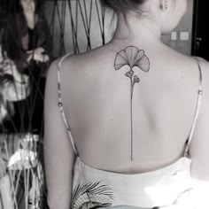 a woman with a flower tattoo on her back