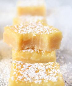 three pieces of cake sitting on top of a table covered in powdered sugar and sprinkles