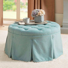 a blue ottoman with a cup and saucer on it