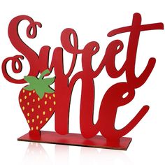 a red metal sign that says sweet one with a strawberry on the front and bottom