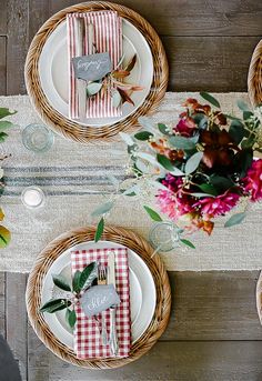 the table is set with place settings and flowers