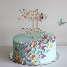 a birthday cake with butterflies on it