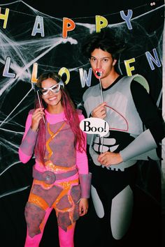 two people dressed in costumes posing for a photo