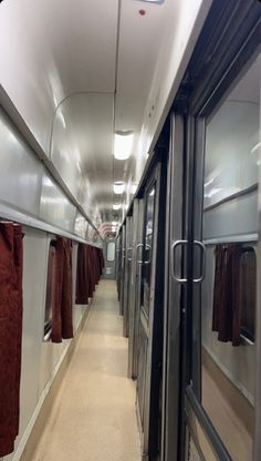 the inside of a train car with red towels hanging from it's rails and windows