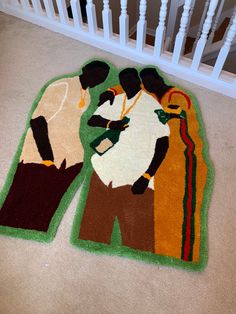 two rugs that are on the ground in front of a stair rail and railing