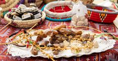 a plate full of food on a table next to baskets and other items in baskets