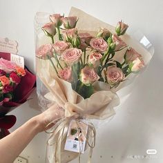 a bouquet of pink roses wrapped in cellophane