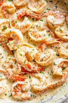 the shrimp is cooked and garnished with parsley in a white sauce, ready to be eaten