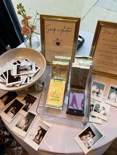 a table topped with pictures and framed photos