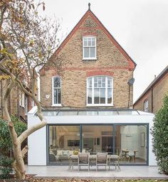 a modern house with an extension to the rear patio and dining room is seen in this image