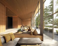 a living room filled with lots of furniture and large glass windows on top of it