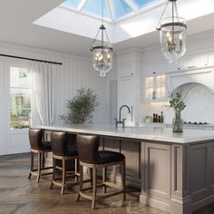 a large kitchen with an island and bar stools