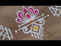 some white and pink designs on a wooden surface