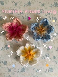 three crocheted flowers on a floral background