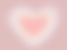 a blurry pink heart shaped object on a light pink background with white and red highlights