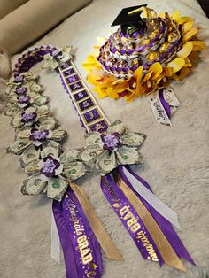 purple and gold ribbons with flowers on them