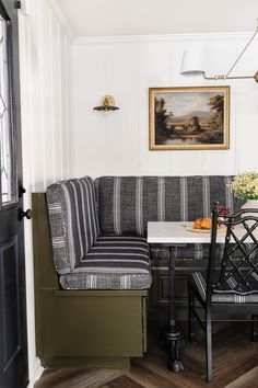 a black and white striped couch sitting next to a table