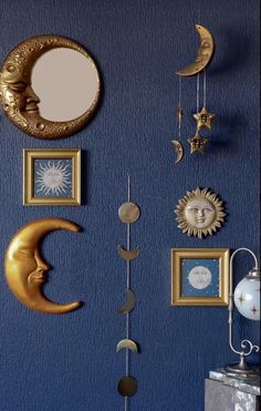 a blue wall with various pictures and clocks on it's sides, including the moon