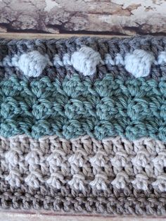 a crocheted dishcloth with three different colors