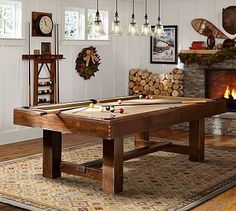 an image of a pool table in the middle of a room with fireplace and pictures on the wall