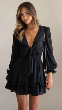 Details: Plunging V neckline Mini dress Front bowtie design Long sleeves Size and Fit: Size Length Bust S 72cm/28.3'' 83cm/32'' M 73cm/28.7'' 87cm/34.2'' L 74cm/29.1'' 93cm/36.6'' XL 79cm/29.5'' 97cm/38.2'' Tiered Ruffle Skirt, Lined Skirt, Feminine Design, Ruffle Skirt, Types Of Dresses, Balloon Sleeves, Mini Dress With Sleeves, Xl Dress, Black Long Sleeve