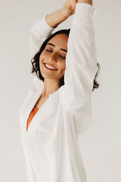 a woman is smiling and stretching her arms