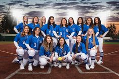 the softball team is posing for a photo on the field at sunset with their coach