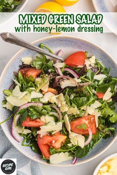 mixed green salad with honey - lemon dressing in a blue bowl on a white table